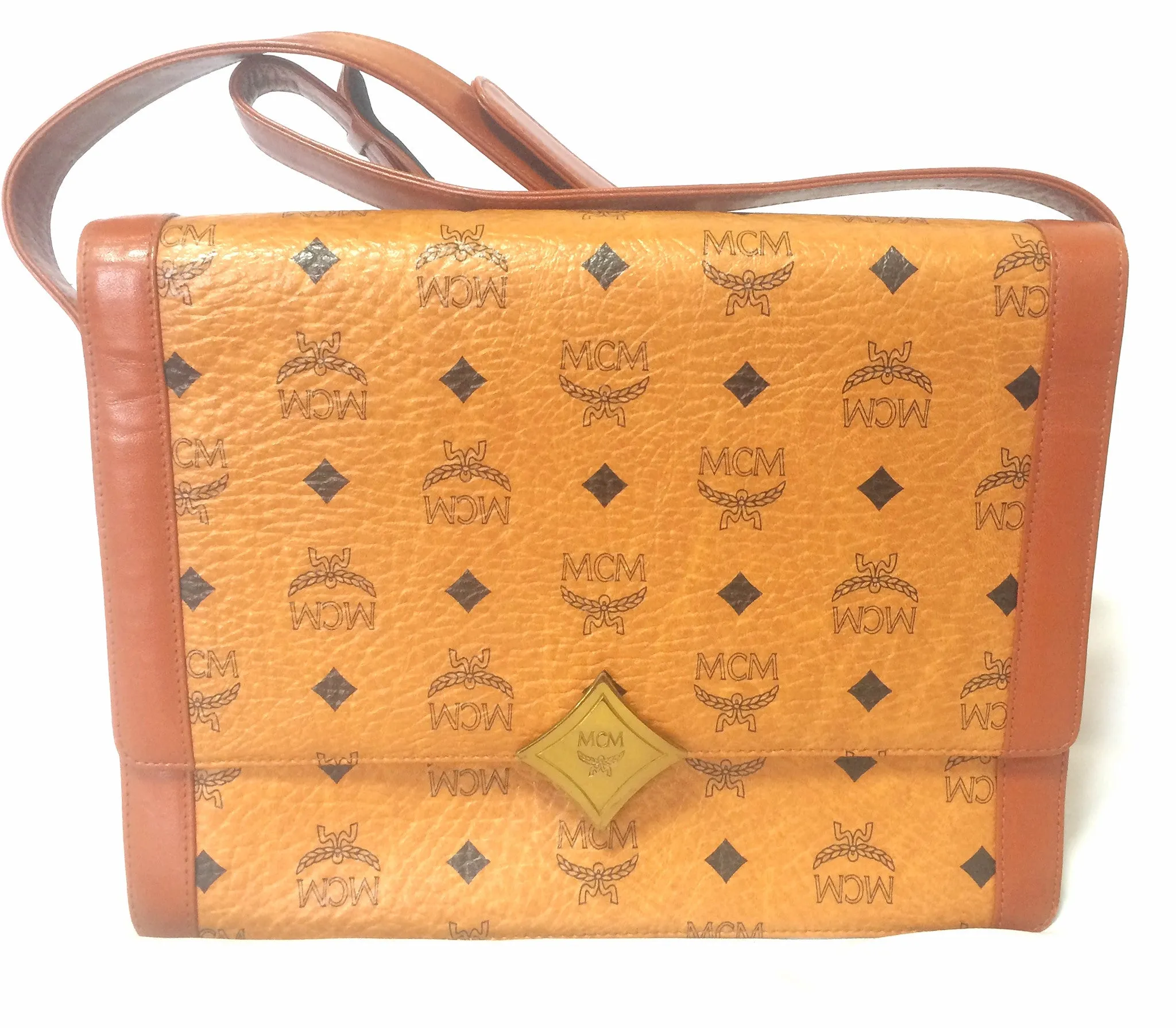 Vintage MCM brown monogram shoulder bag with leather straps and golden star shape logo motif closure. Designed by Michael Cromer. 060621r1