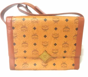 Vintage MCM brown monogram shoulder bag with leather straps and golden star shape logo motif closure. Designed by Michael Cromer. 060621r1